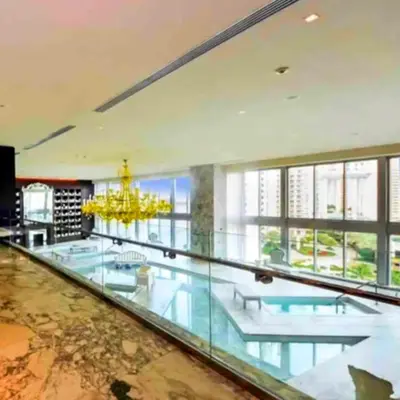 a large lobby with a glass floor and a chandelier at Vacation Apartment for Couples in Miami in Miami