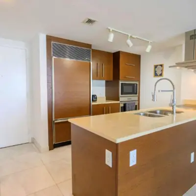 a large kitchen with a sink and a refrigerator at Vacation Apartment for Couples in Miami in Miami
