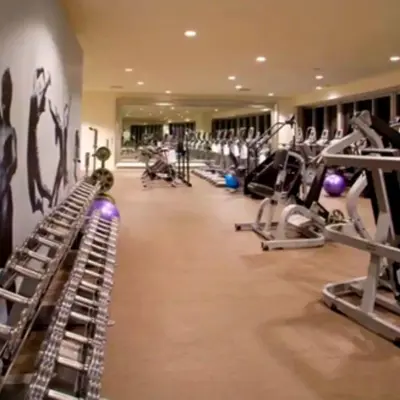 a gym with several treadmills and machines at Vacation Apartment for Couples in Miami in Miami
