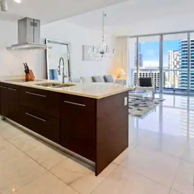 a kitchen with a sink and a living room at Vacation Apartment for Couples in Miami in Miami