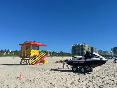 a boat on a trailer on a beach at Beachfront Apt in Carlyle Hotel on Ocean Drive in Miami Beach