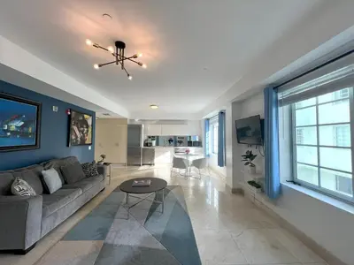 a living room with a couch and a table at Beachfront Apt in Carlyle Hotel on Ocean Drive in Miami Beach