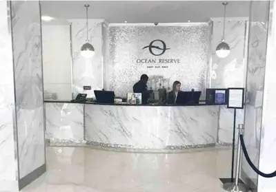 a lobby of an office with two people sitting at a counter at Ocean Reserve 222 STR-2158 in Miami Beach