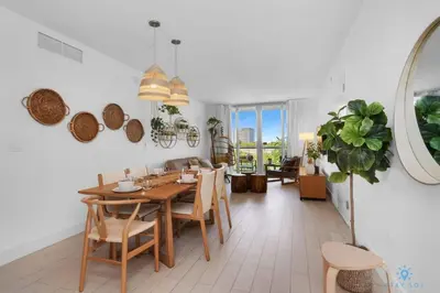 a dining room with a table and chairs at Tropical Apartment with Balcony - Pool - Up To 4 - Gym in Hallandale Beach