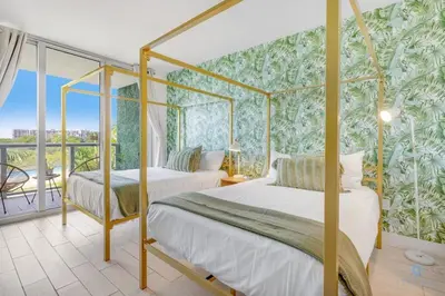 two beds in a room with a wall of plants at Tropical Apartment - Balcony - Resort, Pool - Gym in Hallandale Beach