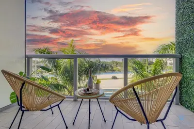 a room with a balcony with a table and chairs at Tropical Apartment - Balcony - Resort, Pool - Gym in Hallandale Beach