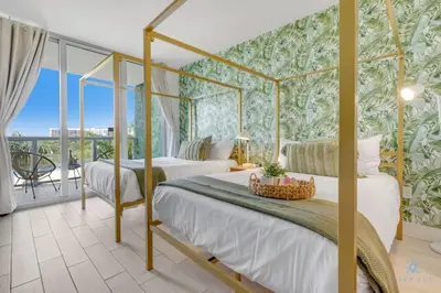 a bedroom with two beds and a balcony at Tropical Apartment - Balcony - Resort, Pool - Gym in Hallandale Beach