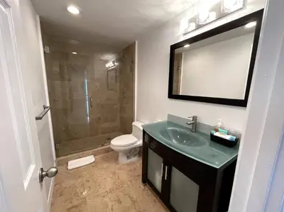 a bathroom with a sink and a toilet and a mirror at Breathtaking ocean view! 15th floor in Miami Beach