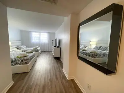 a room with two beds and a large mirror at Breathtaking ocean view! 15th floor in Miami Beach