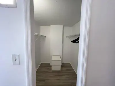 a hallway with a white room with a shelf and a table at Breathtaking ocean view! 15th floor in Miami Beach