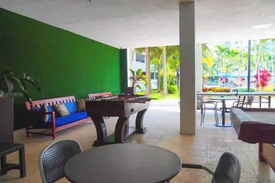 a room with a ping pong table and a green wall at Breathtaking ocean view! 15th floor in Miami Beach