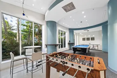a living room with a pool table and ping pong ball at Oceanfront Luxury Condo - Private Beach Access, Pool & Game Room in Hollywood