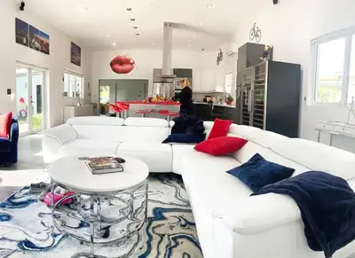 a living room with a white couch and a table at Modern Northwest Vacation Rentals in Miami in Miami