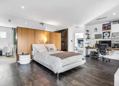 a bedroom with a bed and a desk and a chair at Modern Northwest Vacation Rentals in Miami in Miami