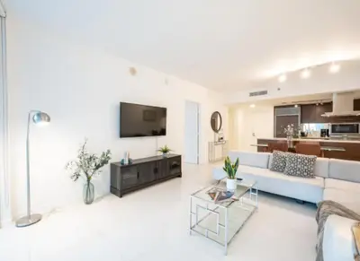 a living room with a couch and a tv at Vacation Apartment in Miami in Miami
