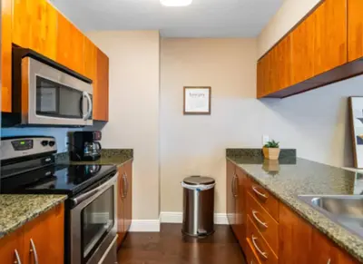 a kitchen with a stove and a microwave at Modern Vacation Apartment in Miami in Miami