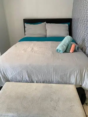 a bed with two pillows on top of it at Small House Near Airport Beach - Wynwood in Miami