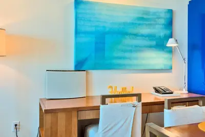 a desk with a blue painting on the wall at 1 BR at Fort Lauderdale in Fort Lauderdale