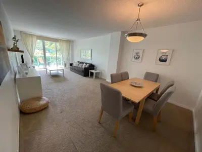 a living room with a wooden table and chairs at Ocean Reserve 207 - STR 2270 in Miami Beach