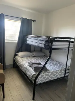 a bedroom with two bunk beds in a room at Bekahouse Hostel with parking, backyard and laundry in Miami