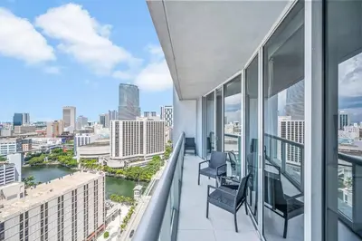 a balcony with two chairs and a view of a city at Gorgeous Unit At The W Building Priceless Location in Miami