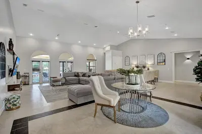 a living room with a couch and a table at Villa wpool mini-golf firepits in Davie