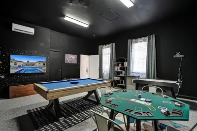 a room with a pool table and a tv at Villa wpool mini-golf firepits in Davie