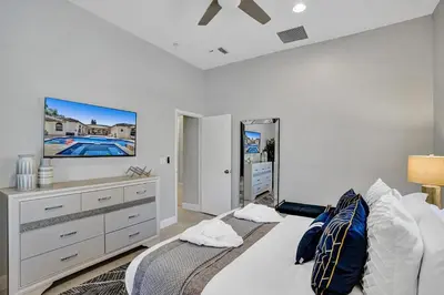 a bedroom with a bed and a tv on the wall at Villa wpool mini-golf firepits in Davie