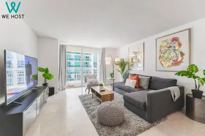 a living room with a couch and a tv at Wonderful Condo in Brickell With Pool and Gym in Miami