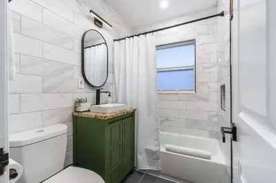 a bathroom with a sink and a toilet and a mirror at Swim, Dine, and Relax - Your private paradise awaits in Fort Lauderdale