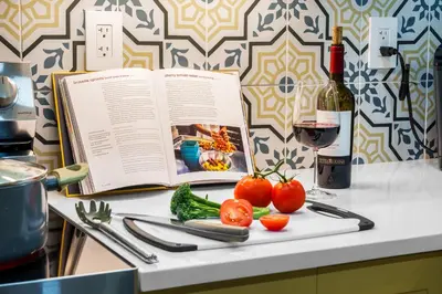 a book and vegetables on a counter with a bottle of wine at Swim, Dine, and Relax - Your private paradise awaits in Fort Lauderdale