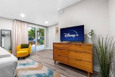 a bedroom with a dresser with a tv on it at Swim, Dine, and Relax - Your private paradise awaits in Fort Lauderdale