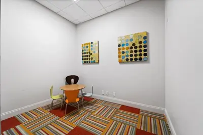 a room with a table and three paintings on the wall at Hollywood Beachfront Condo, Steps to Ocean, Pool & Game Room in Hollywood