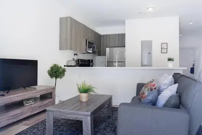 a living room with a couch and a tv and a table at Awesome 3BR Townhouse 15minutes from the Beach in Miami