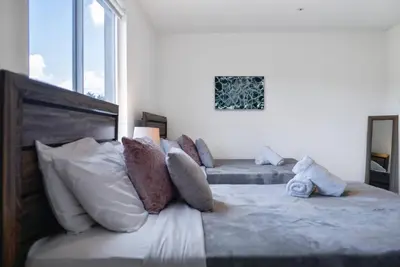 a bedroom with two beds and a large window at Awesome 3BR Townhouse 15minutes from the Beach in Miami