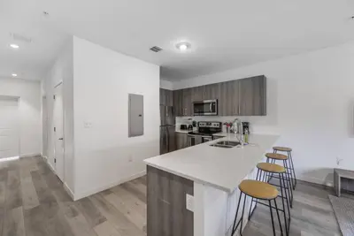 a kitchen with a white counter and stools at Amazing Townhouse 15 minutes from the Beach in Miami