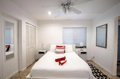 a white bedroom with a white bed with a white ceiling at B efficiency Off Las Olas on water free kayaks in Fort Lauderdale