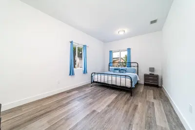 a bedroom with a bed and a wooden floor at Pool Boutique Villa by the Beach 1 in Hallandale Beach