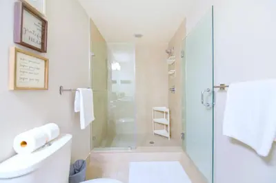 a bathroom with a shower and a toilet and a sink at Modern Hotel with Pool & Gym in Prime Doral Location in Miami
