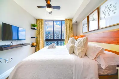 a bedroom with a bed and a large window at Modern Hotel with Pool & Gym in Prime Doral Location in Miami