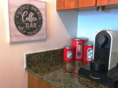 a kitchen counter with a coffee bar sign on the wall at Condo in Brickell Business District in Miami