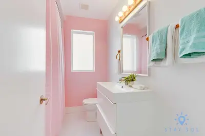 a bathroom with a sink and a toilet and a mirror at Free Parking, Bay View, Pool, Step To Beach in Hollywood