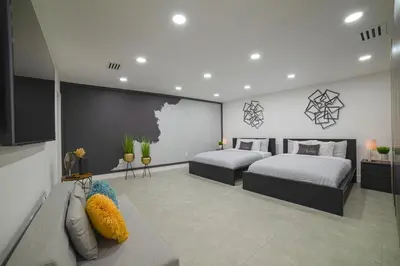 a bedroom with two beds and a couch at Heated pool in a Precious House close to Zoo Parks and Arts in Cutler Bay