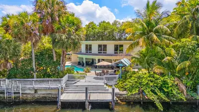 an aerial view of a house with palm trees at Waterfront Retreat: 7BR Villa with Pool Firepit in Fort Lauderdale