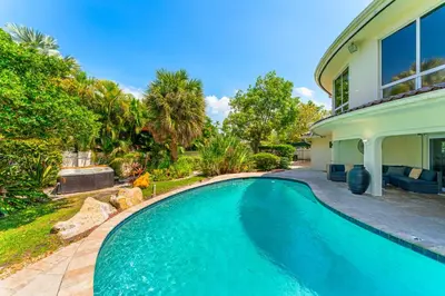 a swimming pool in the backyard of a house at Waterfront Retreat: 7BR Villa with Pool Firepit in Fort Lauderdale