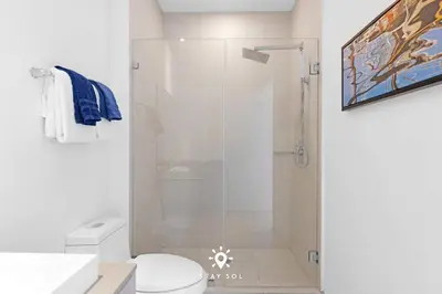 a bathroom with a shower with a toilet and a sink at Beachfront Condo - Amazing Pool - Oceanview Balcony in Hollywood