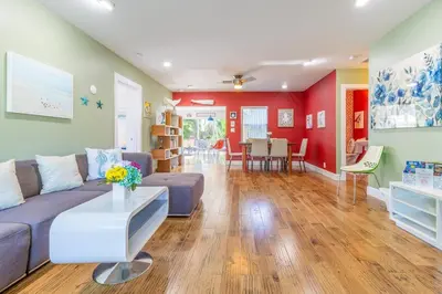 a living room with a couch and a table at Fun Family-Friendly Poolside Escape Near Beach in Dania Beach