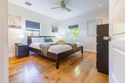 a bedroom with a bed and a ceiling fan at Fun Family-Friendly Poolside Escape Near Beach in Dania Beach