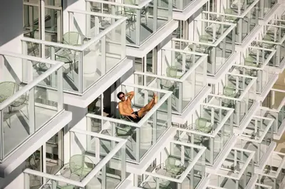 a man sitting on a window ledge of a building at Arlo Wynwood Miami in Miami