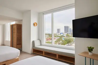 a room with a window with a bed and a tv at Arlo Wynwood Miami in Miami
